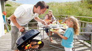 Family on vacation having barbecue